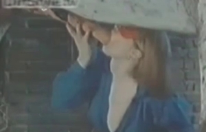 The dick of a horse is blown by a woman in a mask